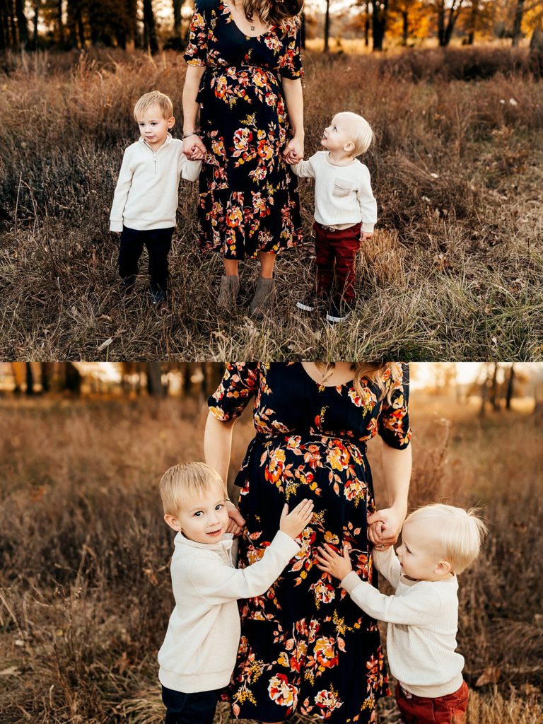 two boys touching mom's belly during a maternity photography session in St. Louis