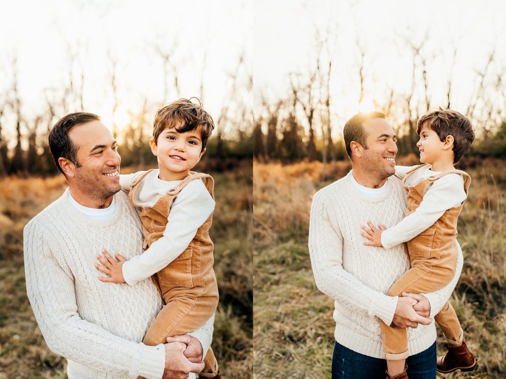 dad holding son in yellow overalls during a winter family session in St. Louis 