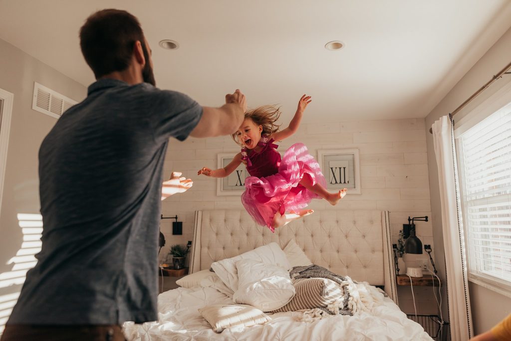 dad throwing daughter on bed for a 365 project in St. Louis 