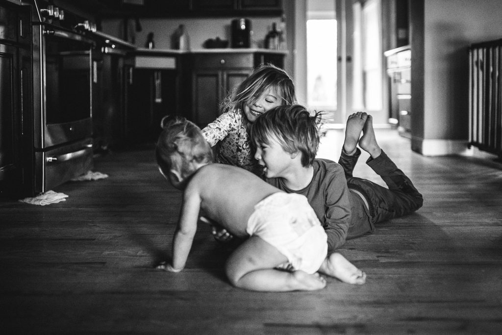 kids sitting on kitchen floor of St. Louis home while mom makes some family-friendly-soups 