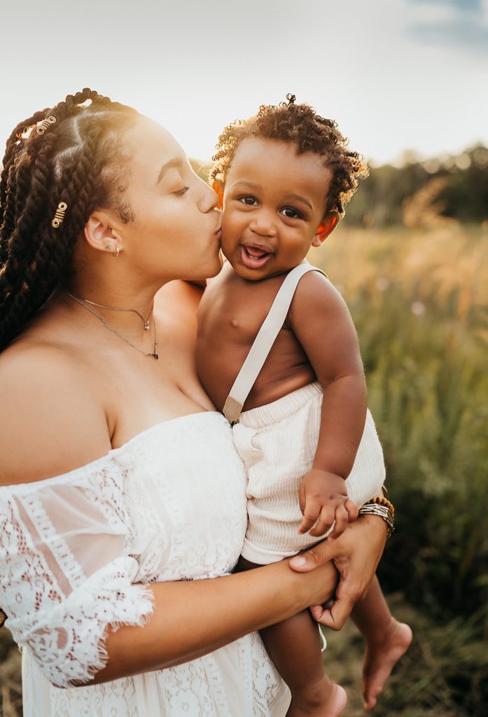 mom kissing baby boy on the cheek during a St. Louis Family photography session 