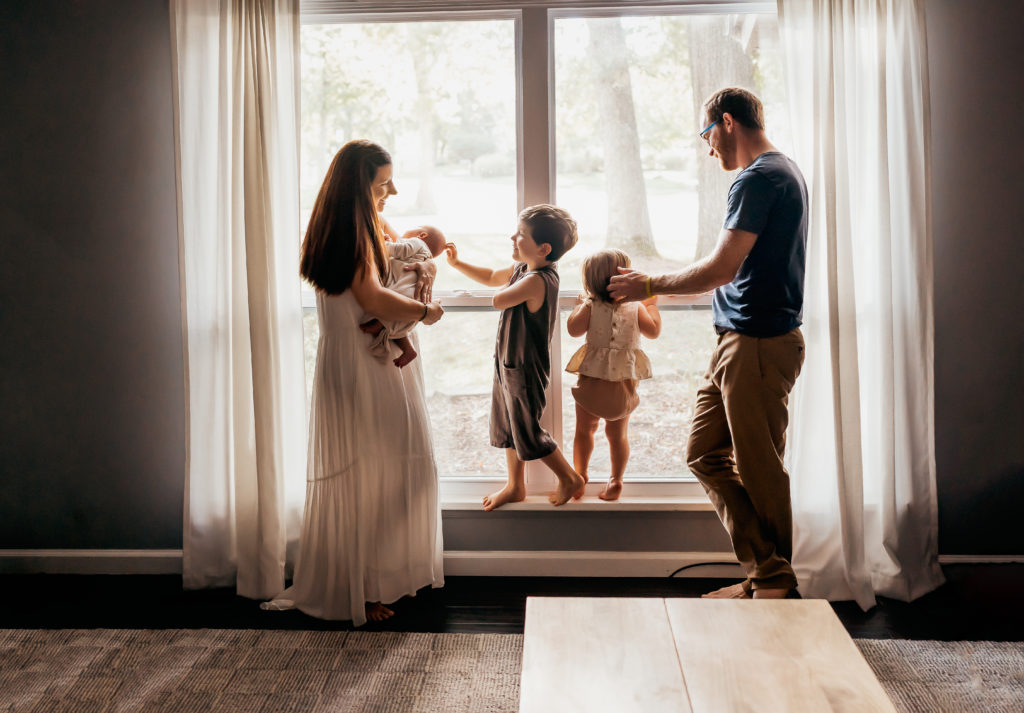 family standing window during a session from the 2021 year in review 