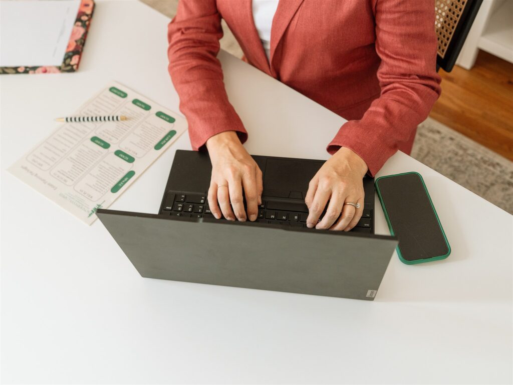Flat lay styled props including a laptop, coffee mug, and notepad during a St. Louis branding photoshoot